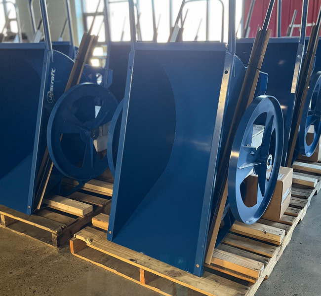 Warehouse full of blue wheel barrels staged for packout