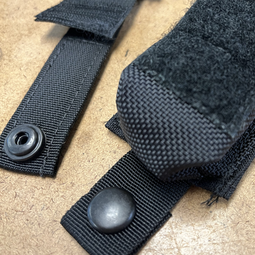 Fasteners sewn onto a flashlight pouch